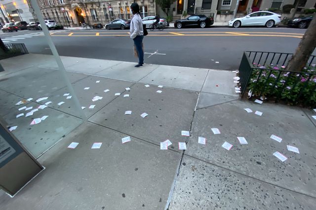 A photo of lotto tickets all over the ground on the UWS